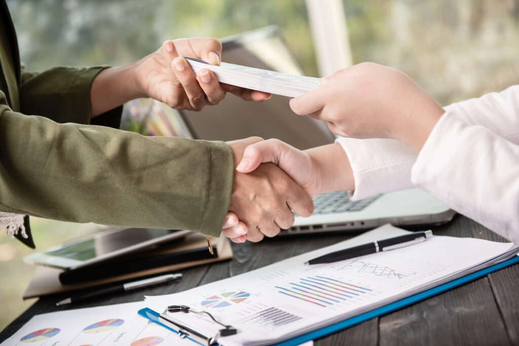 business people shaking hands finishing up meeting